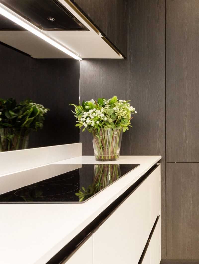 Tudor place project modern white kitchen with a vase of flowers