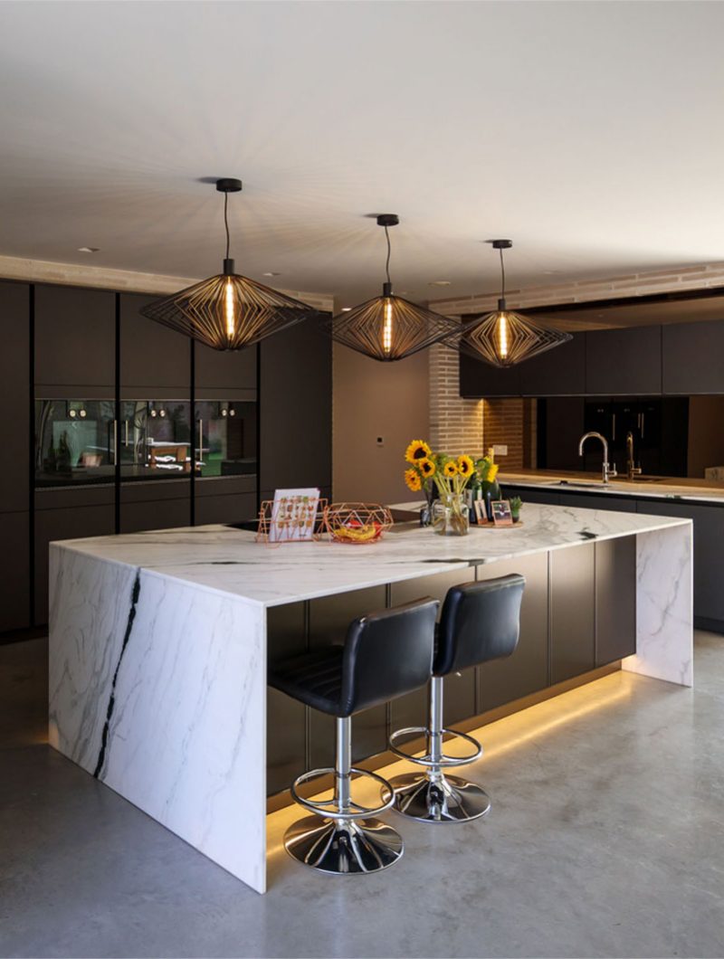 Studio Spicer project Kitchen Island with waterfall countertop and 3 pendant lights above